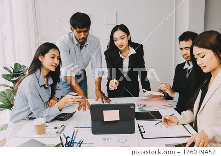Team of financial advisory services. Asian advisor showing plan of investment to clients in the consultancy office. Team of financial advisory services. Asian advisor showing plan of investment to clients in the consultancy office. 126019452