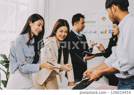 Team of financial advisory services. Asian advisor showing plan of investment to clients in the consultancy office. Team of financial advisory services. Asian advisor showing plan of investment to clients in the consultancy office. 126019454