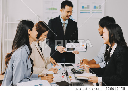 Team of financial advisory services. Asian advisor showing plan of investment to clients in the consultancy office. Team of financial advisory services. Asian advisor showing plan of investment to clients in the consultancy office. 126019456