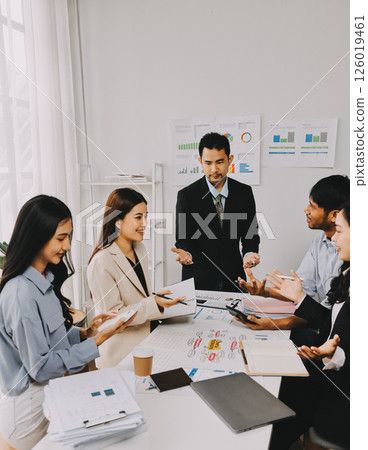 Team of financial advisory services. Asian advisor showing plan of investment to clients in the consultancy office. Team of financial advisory services. Asian advisor showing plan of investment to clients in the consultancy office. 126019461