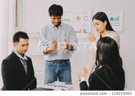 Team of financial advisory services. Asian advisor showing plan of investment to clients in the consultancy office. Team of financial advisory services. Asian advisor showing plan of investment to clients in the consultancy office. 126019463