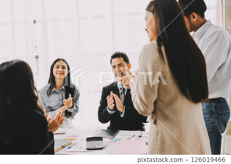 Team of financial advisory services. Asian advisor showing plan of investment to clients in the consultancy office. Team of financial advisory services. Asian advisor showing plan of investment to clients in the consultancy office. 126019466