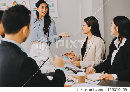 Team of financial advisory services. Asian advisor showing plan of investment to clients in the consultancy office. Team of financial advisory services. Asian advisor showing plan of investment to clients in the consultancy office. 126019469