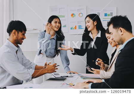 Team of financial advisory services. Asian advisor showing plan of investment to clients in the consultancy office. 126019478