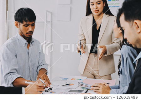 Team of financial advisory services. Asian advisor showing plan of investment to clients in the consultancy office. Team of financial advisory services. Asian advisor showing plan of investment to clients in the consultancy office. 126019489