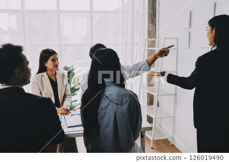 Team of financial advisory services. Asian advisor showing plan of investment to clients in the consultancy office. Team of financial advisory services. Asian advisor showing plan of investment to clients in the consultancy office. 126019490