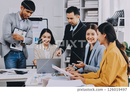 Team of financial advisory services. Asian advisor showing plan of investment to clients in the consultancy office. 126019497