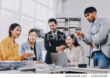 Team of financial advisory services. Asian advisor showing plan of investment to clients in the consultancy office. 126019498