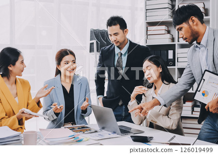 Team of financial advisory services. Asian advisor showing plan of investment to clients in the consultancy office. 126019499