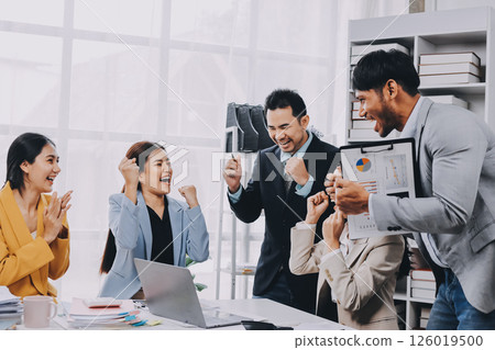 Group of Young Asian business team creative businesspeople coworker in office Happy to be successful partnership teamwork celebrating achievement and success concept. 126019500
