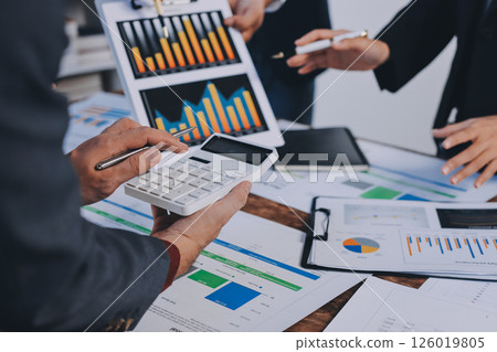 Accounting company provide finance and taxation planning for profitable cash flow, Auditor and accountant team working in office, analyze financial data and accounting record with calculator.Insight Accounting company provide finance and taxation planning for profitable cash flow, Auditor and accountant team working in office, analyze financial data and accounting record with calculator.Insight 126019805