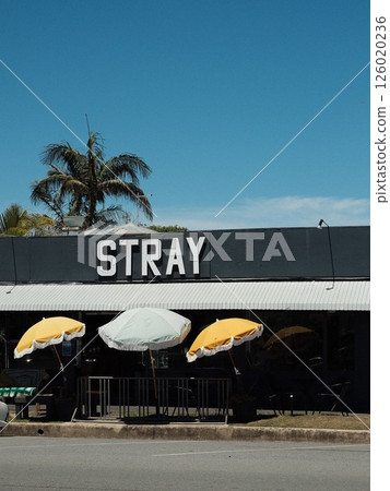 The exterior of an overseas cafe with a cute parasol 126020236
