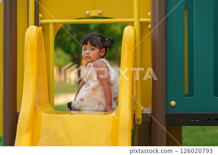 happy toddler baby girl playing at outdoor playground in park 126020793