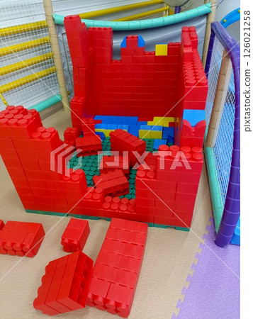 Oversized Red Building Blocks in Children's Play Area with Foam Flooring Oversized Red Building Blocks in Children's Play Area with Foam Flooring 126021258