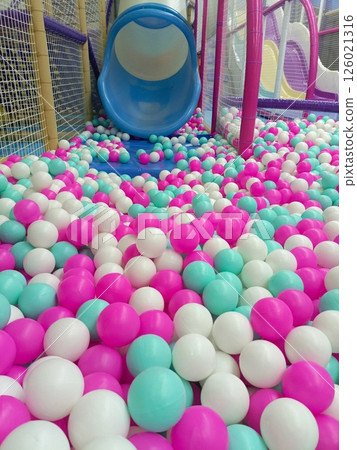 Vibrant Indoor Ball Pit with Pastel Balls and Curved Slide in Play Area with Copy Space 126021316