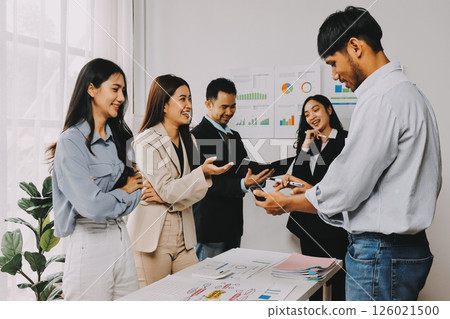 Team of financial advisory services. Asian advisor showing plan of investment to clients in the consultancy office. 126021500