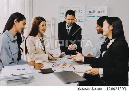 Team of financial advisory services. Asian advisor showing plan of investment to clients in the consultancy office. 126021503