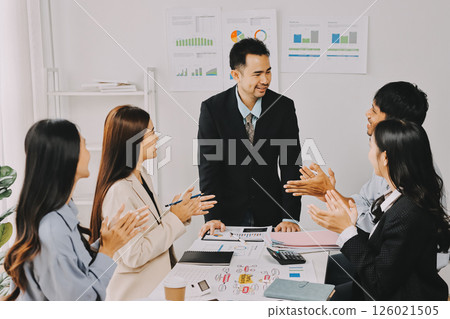 Team of financial advisory services. Asian advisor showing plan of investment to clients in the consultancy office. Team of financial advisory services. Asian advisor showing plan of investment to clients in the consultancy office. 126021505