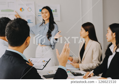 Team of financial advisory services. Asian advisor showing plan of investment to clients in the consultancy office. 126021510