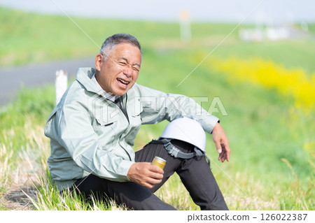A senior supervisor taking a break with a can of coffee in hand 126022387