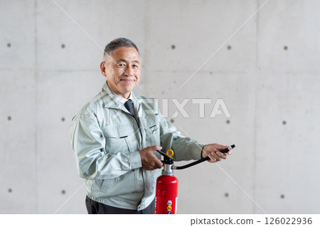 Safety management staff with fire extinguishers Safety management staff with fire extinguishers 126022936