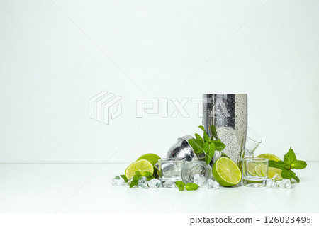 Metal shaker with fresh lime on a light background 126023495