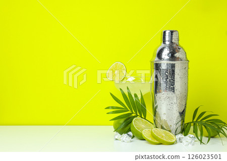 Shaker with fresh lime and glass on light background Shaker with fresh lime and glass on light background 126023501