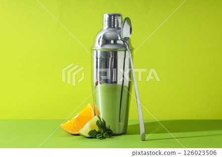 Metal shaker with fresh lime and orange Metal shaker with fresh lime and orange 126023506