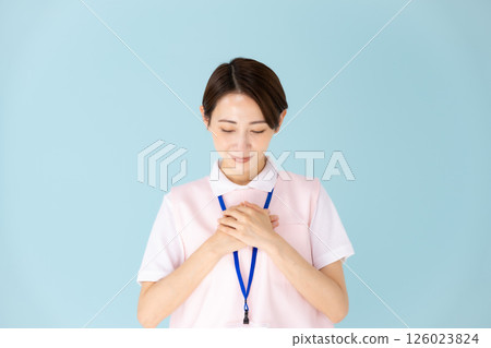 Woman in apron, caregiver, nursery teacher, medical, peace of mind Woman in apron, caregiver, nursery teacher, medical, peace of mind 126023824