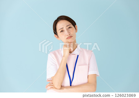 Woman in apron, caregiver, nursery teacher, medical, worries Woman in apron, caregiver, nursery teacher, medical, worries 126023869