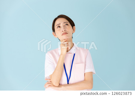 Woman in apron, caregiver, nursery teacher, medical, worries Woman in apron, caregiver, nursery teacher, medical, worries 126023873