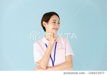 Woman in apron, caregiver, nursery teacher, medical, planning Woman in apron, caregiver, nursery teacher, medical, planning 126023877