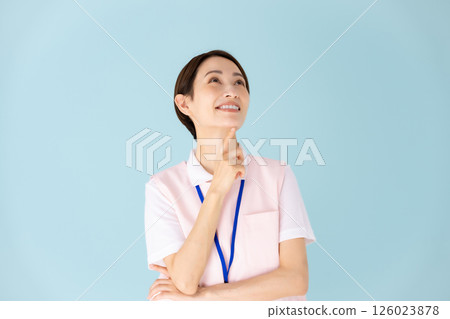 Woman in apron, caregiver, nursery teacher, medical, planning Woman in apron, caregiver, nursery teacher, medical, planning 126023878