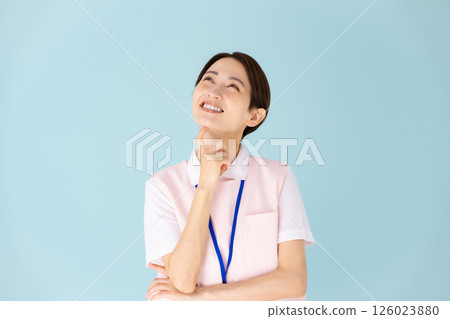 Woman in apron, caregiver, nursery teacher, medical, planning Woman in apron, caregiver, nursery teacher, medical, planning 126023880