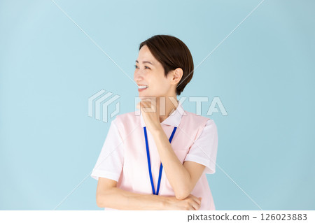 Woman in apron, caregiver, nursery teacher, medical, planning Woman in apron, caregiver, nursery teacher, medical, planning 126023883