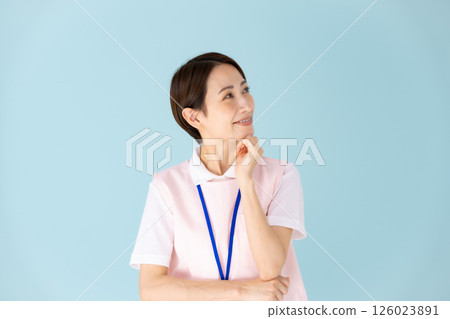 Woman in apron, caregiver, nursery teacher, medical, planning Woman in apron, caregiver, nursery teacher, medical, planning 126023891