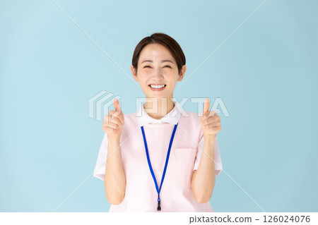 Apron woman caregiver nursery teacher medical thumbs up 126024076