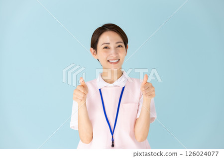 Apron woman caregiver nursery teacher medical thumbs up 126024077