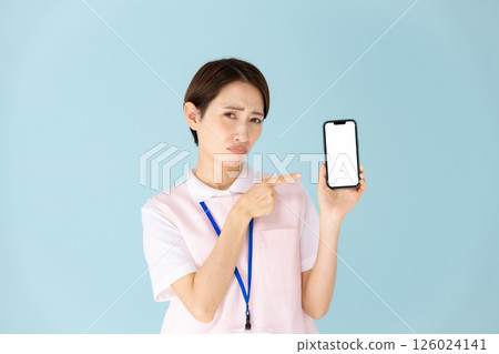 Woman in apron, caregiver, nursery teacher, medical, smartphone Woman in apron, caregiver, nursery teacher, medical, smartphone 126024141