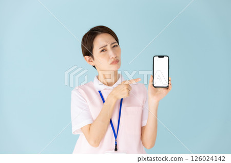 Woman in apron, caregiver, nursery teacher, medical, smartphone 126024142