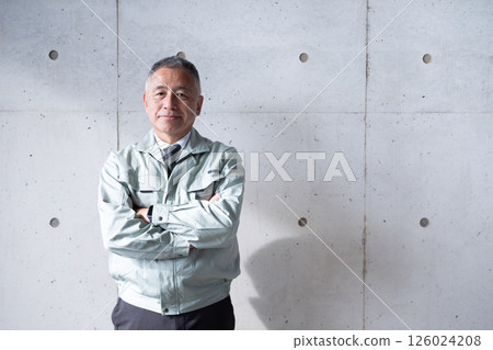 A veteran man standing tall and confidently supporting a construction site 126024208