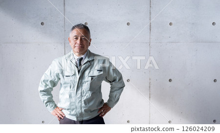 A veteran man standing tall and confidently supporting a construction site 126024209