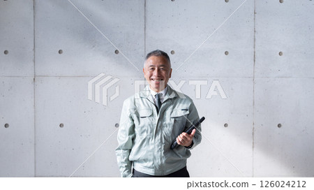 A veteran man standing tall and confidently supporting a construction site 126024212
