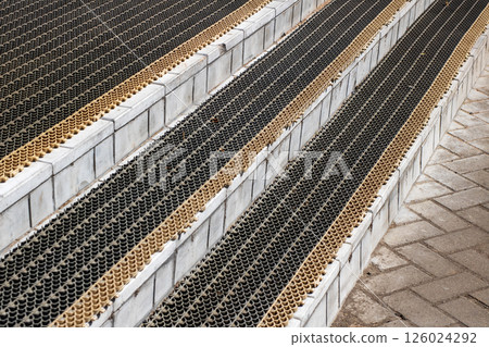 Close up of stairs with a black and gold mat on them Close up of stairs with a black and gold mat on them 126024292