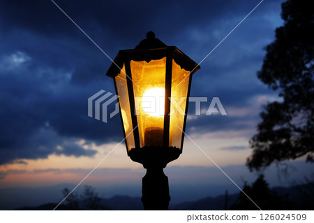 Classic and vintage black iron street light in strom and dark cloud sky with twilight in the evening night Classic and vintage black iron street light in strom and dark cloud sky with twilight in the evening night 126024509
