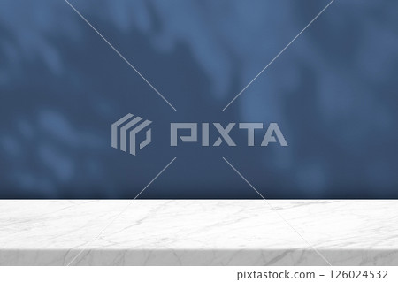 White Marble Table with Light Beam, Shadow, and Spotlight on the Blue Concrete Wall Background 126024532