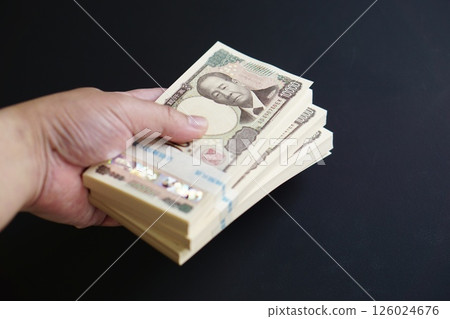 The moment you hold a stack of 10,000 yen bills in your hand 126024676