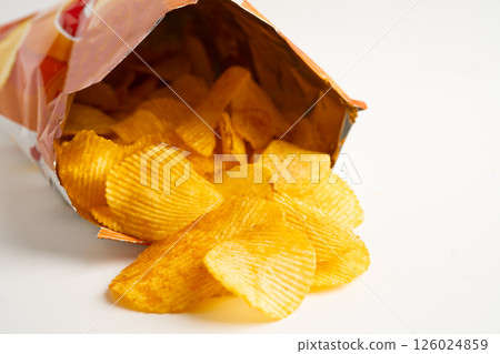 Potato chips, delicious BBQ seasoning spicy for crips, thin slice deep fried snack fast food in open bag. Potato chips, delicious BBQ seasoning spicy for crips, thin slice deep fried snack fast food in open bag. 126024859