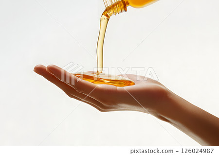 Close-up of pouring beauty oil into hands 126024987