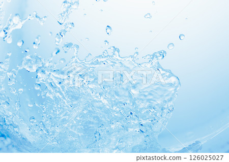 Splashes of water dancing like waves on a blue background. 126025027